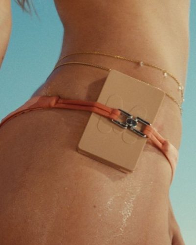 Alexis Ren wearing a ribbed bikini in vibrant peach color