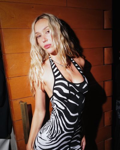 Alexis Ren in fashionable zebra print dress with knee-high socks