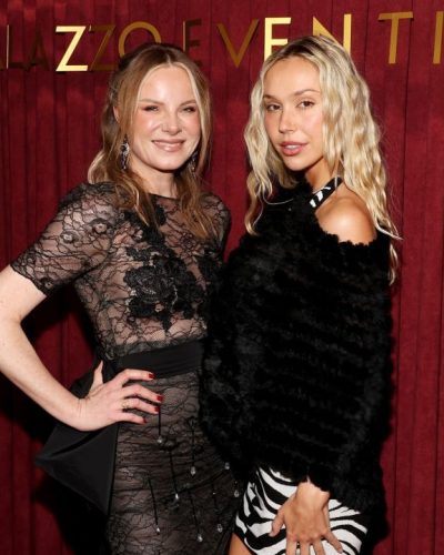 Alexis Ren sleek black ankle boots matched with zebra print gown