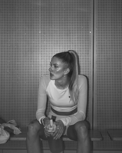 Alica Schmidt in cropped white top paired with red shorts