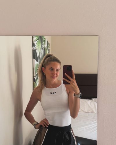 Alica Schmidt in stylish white zip-up jacket and joggers