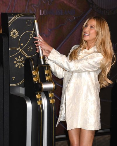 Alix Earle in a cream-colored peep-toe pump