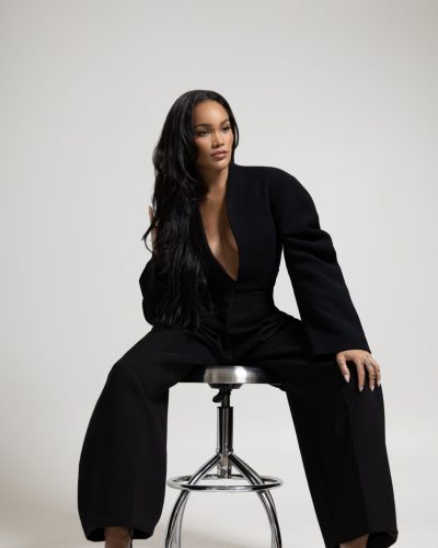 Allyiah Gainer in simple black ensemble with statement jewelry