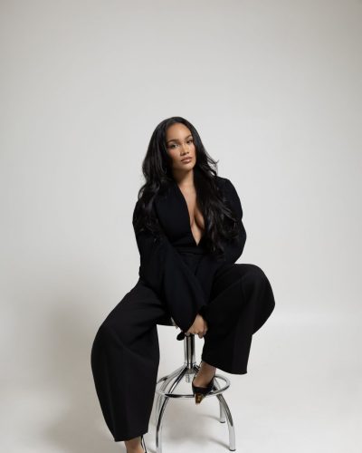 Allyiah Gainer in modern black outfit with eye-catching gold details