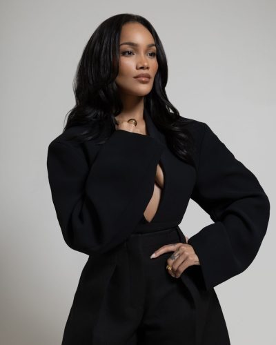 Allyiah Gainer in classic black dress featuring bold gold jewelry
