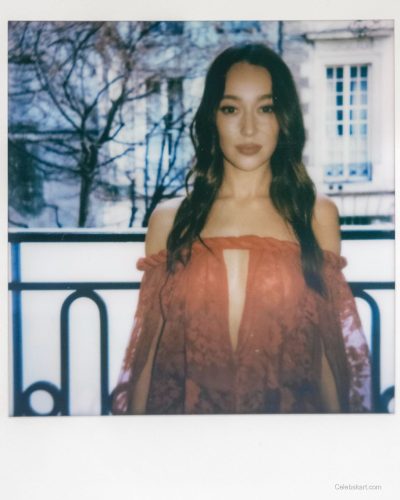 Alycia Debnam-Carey wearing bold red lace gown with graceful silhouette.