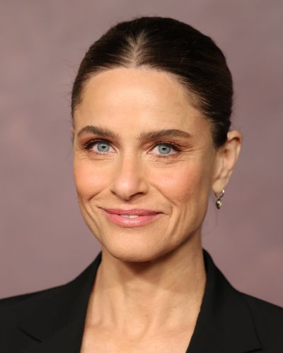 Amanda Peet wearing classic black heels with a black blazer.