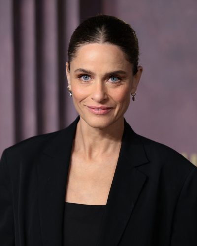 Amanda Peet in a black fringed skirt and sleek heels.