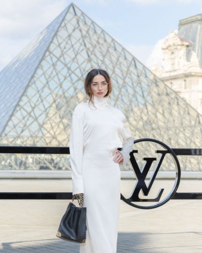 Ana de Armas wearing a long-sleeve black dress with cutout back.