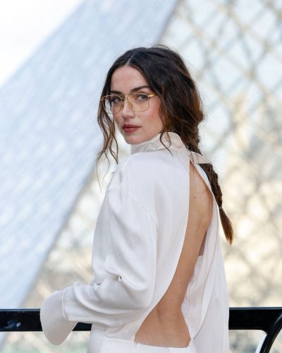Ana de Armas in a chic black gown paired with a black handbag.