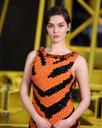 Anamaria Vartolomei wearing ruffled neckline orange gown