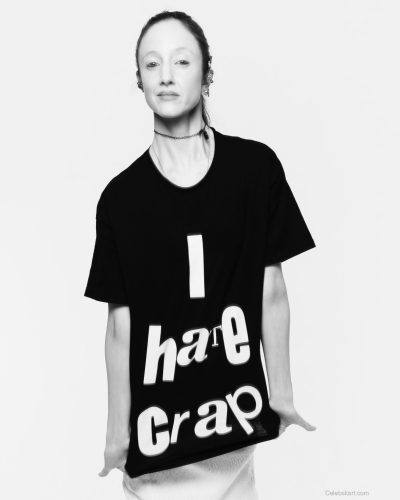 Andrea Riseborough in black tee and stylish white midi skirt