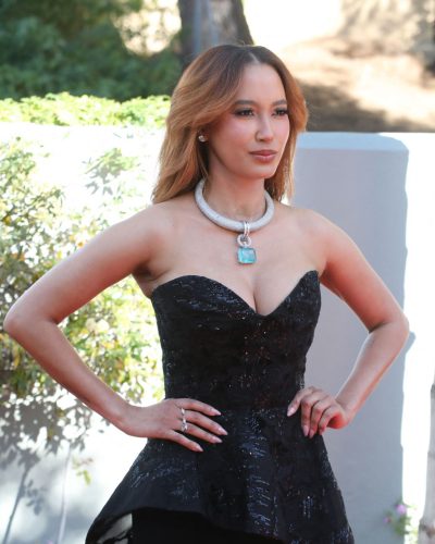 Andy Allo wearing a black gown complemented by turquoise