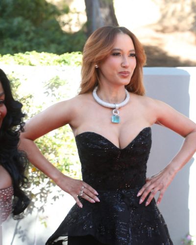 Andy Allo in a sleek black gown shimmering in sunlight