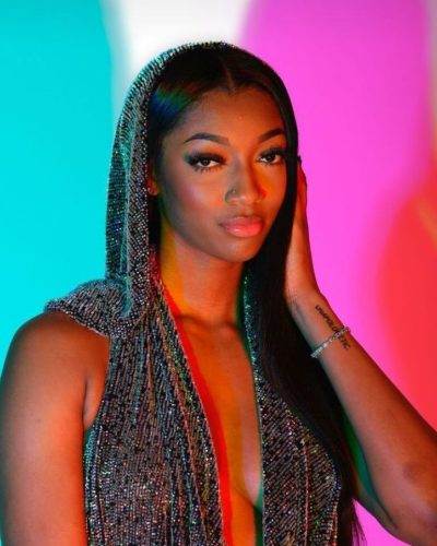 Angel Reese silver gown with a contemporary hooded feature.