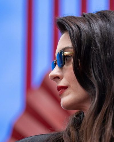 Anne Hathaway fitted black dress featuring eye-catching gold accents