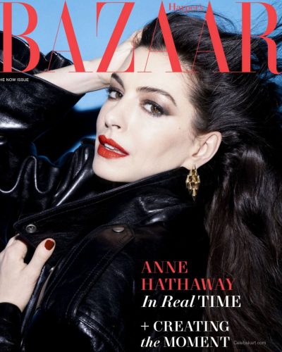 Anne Hathaway in black textured waistcoat with statement bracelet.