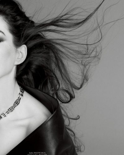 Anne Hathaway featuring bold black waistcoat and glamorous accessories.