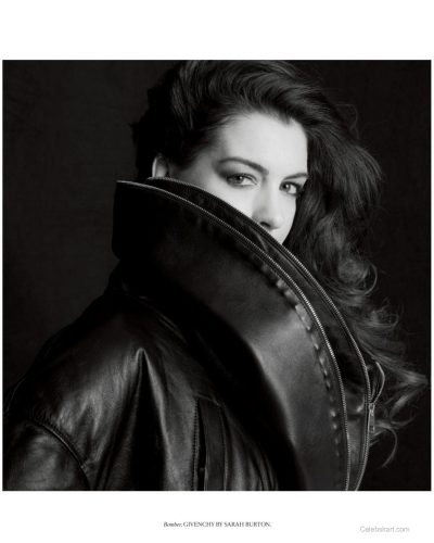 Anne Hathaway styled with black waistcoat and striking accessories.