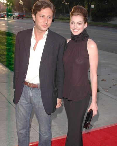 Anne Hathaway chic black clutch with tailored black pants