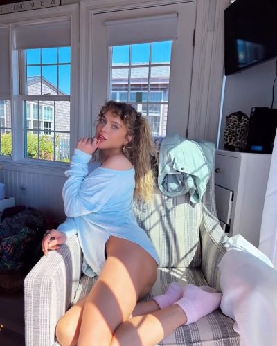 Anne Winters stylish red top and trendy denim shorts