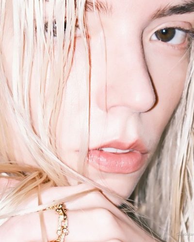 Anya Taylor-Joy wearing a white dress complemented by gold jewelry