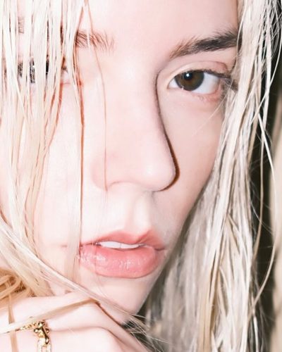 Anya Taylor-Joy in minimal white dress with gold jewelry