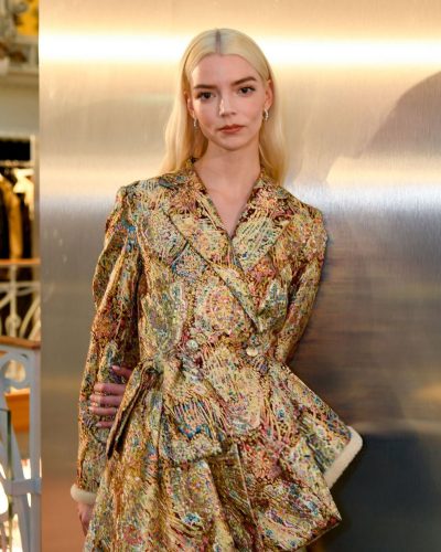 Anya Taylor-Joy metallic gold coat and fitted denim pants