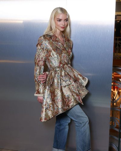 Anya Taylor-Joy shimmering gold coat with tailored denim