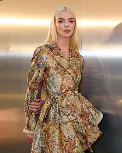 Anya Taylor-Joy gold coat complemented by light denim pants