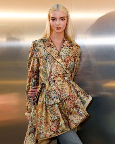 Anya Taylor-Joy glimmering gold outerwear and fitted denim