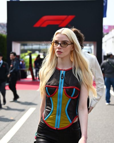 Anya Taylor-Joy styled in multicolored mesh top and black pants