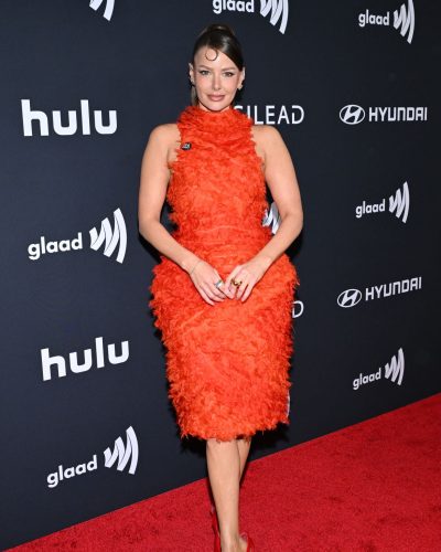 Ariana Madix chic red heels complementing orange dress