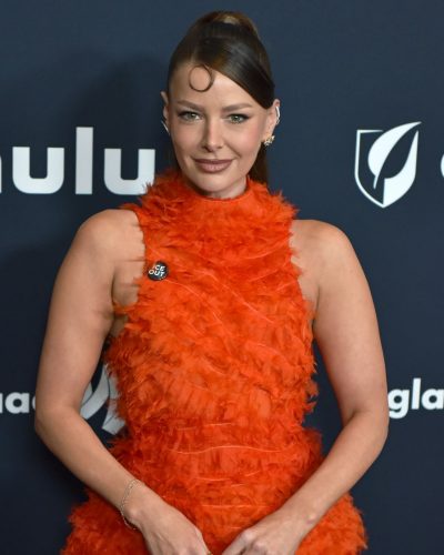 Ariana Madix vibrant orange gown with bold feather details