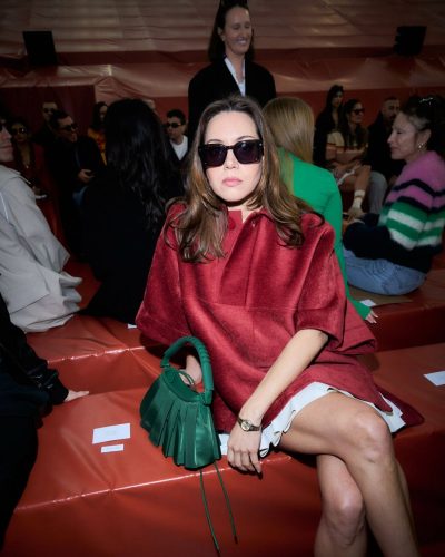 Aubrey Plaza wearing stylish red heels with colorful straps.