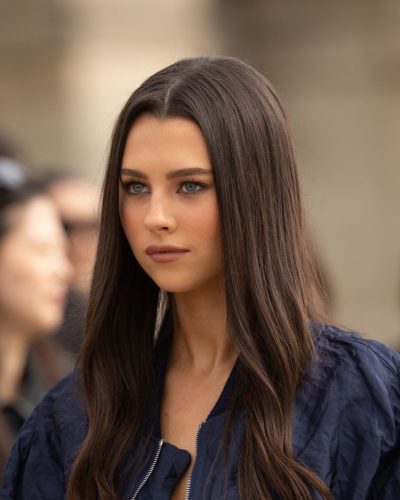 Beau Gadsdon with long hair and gold hoop earrings.