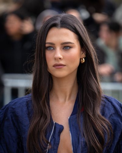 Beau Gadsdon wearing a textured navy bomber jacket and fitted skirt.