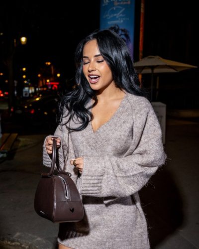 Becky G in knitted dress accentuated by matching belt