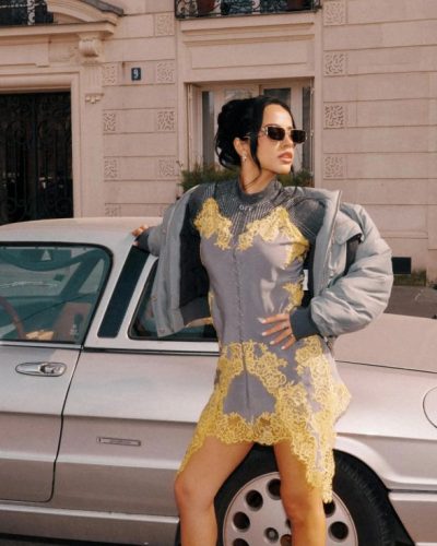 Becky G chic sunglasses complementing gray dress