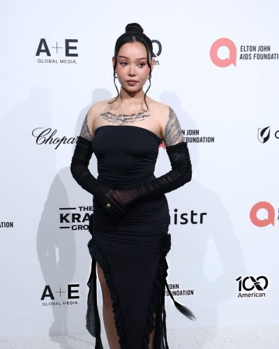 Bella Poarch in black dress with sheer sleeves and ruffles