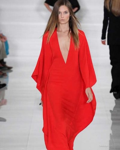 Bridget Malcolm in black bikini laughing with friends outdoors.