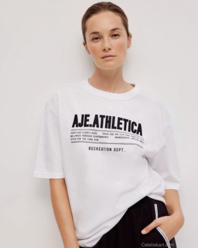 Bridget Malcolm wearing minimalistic black bikini by the coast.