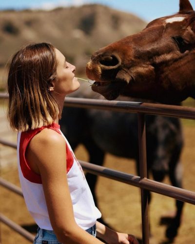 Bridget Malcolm in black bikini with silver necklace.
