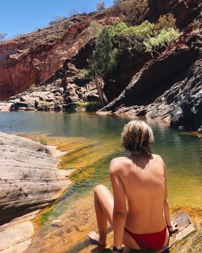 Bridget Malcolm in black bikini, ideal for poolside lounging.