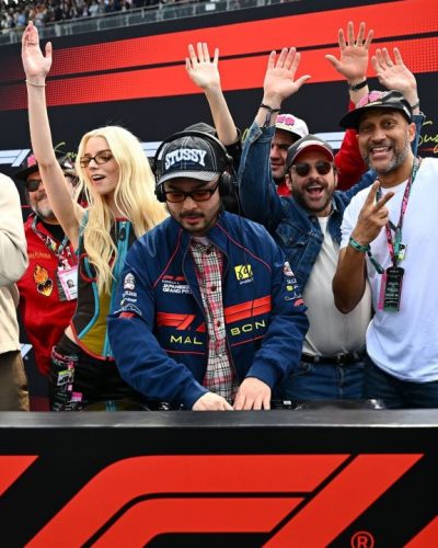 Brie Larson black leather jacket over colorful graphic tee