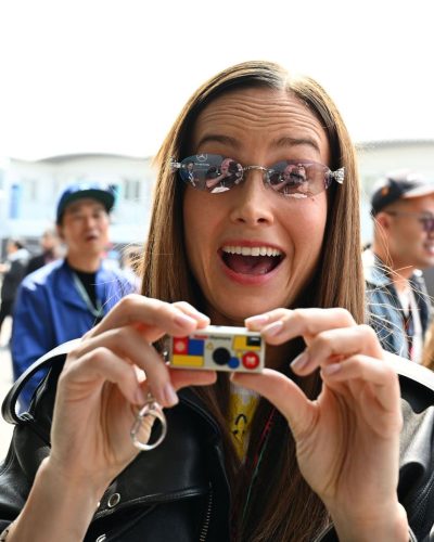 Brie Larson youthful graphic tee under black leather jacket