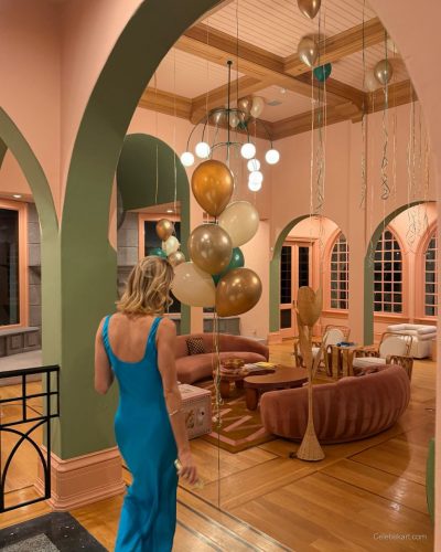 Brittany Snow in a stylish blue gown complemented by red walls