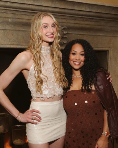 Cameron Brink in a lace top paired with a shiny mini skirt.