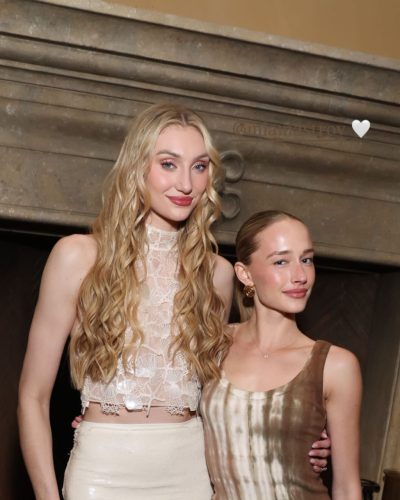 Cameron Brink in a lace top paired with a shiny mini skirt.