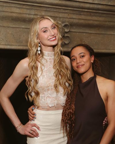 Cameron Brink wearing a soft beige lace top and mini skirt.